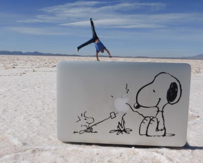 Work Life Balance, Dr. Krengel macht Handstand am Strand hinter Laptop